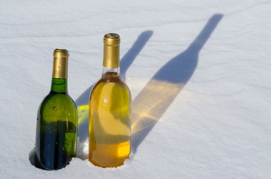 shutterstock_169834526-white-winter-wines Two bottles of white wine chilling in the snow