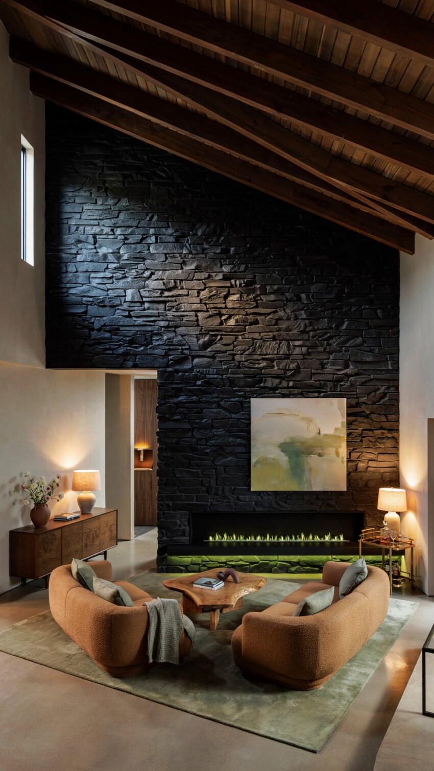 Dark Slate Stone Accent Wall with Curved Boucle Chairs and Live-Edge Table