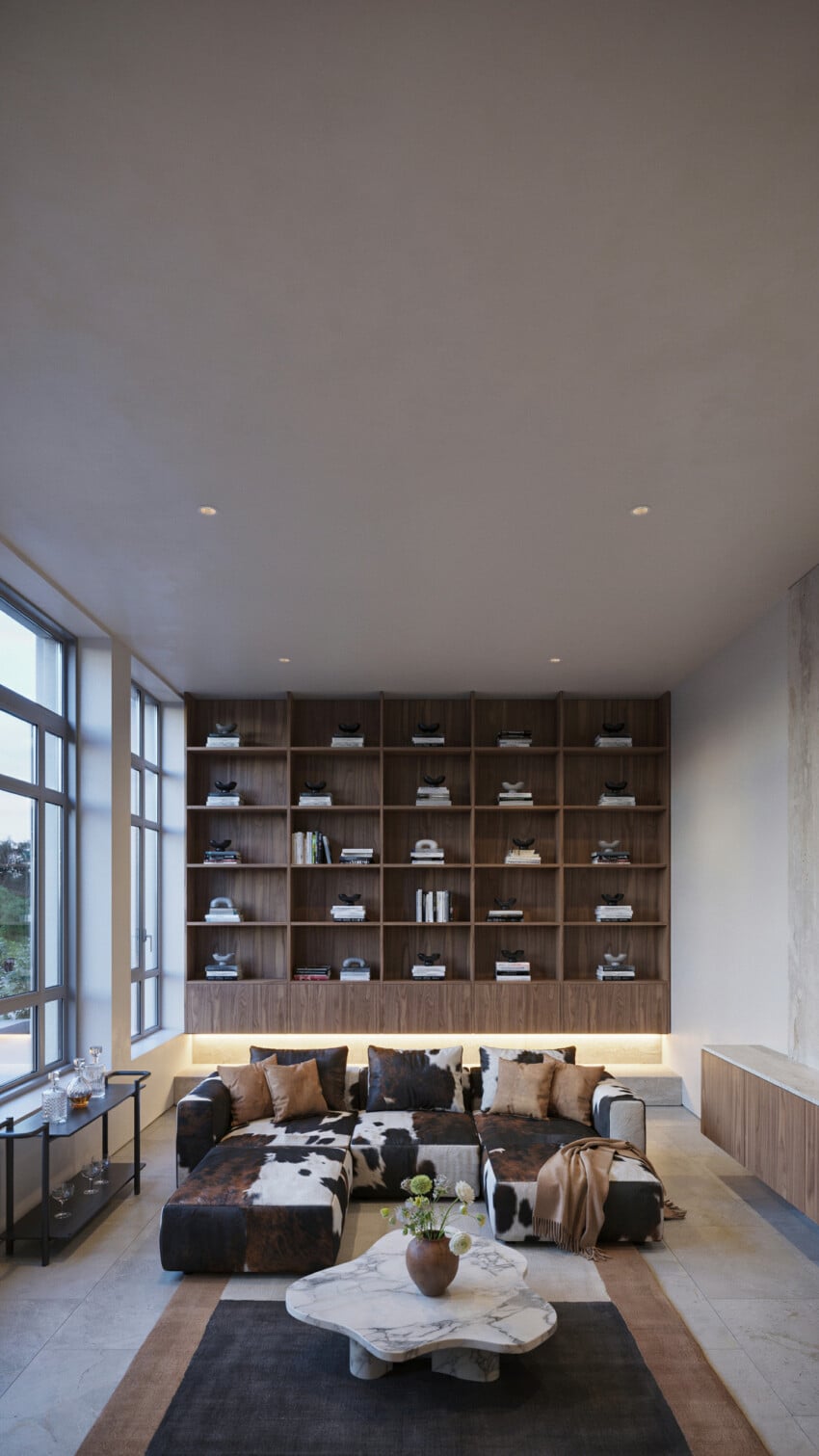 Walnut Grid Bookcase Accent Wall with Cowhide Sectional and Marble Coffee Table