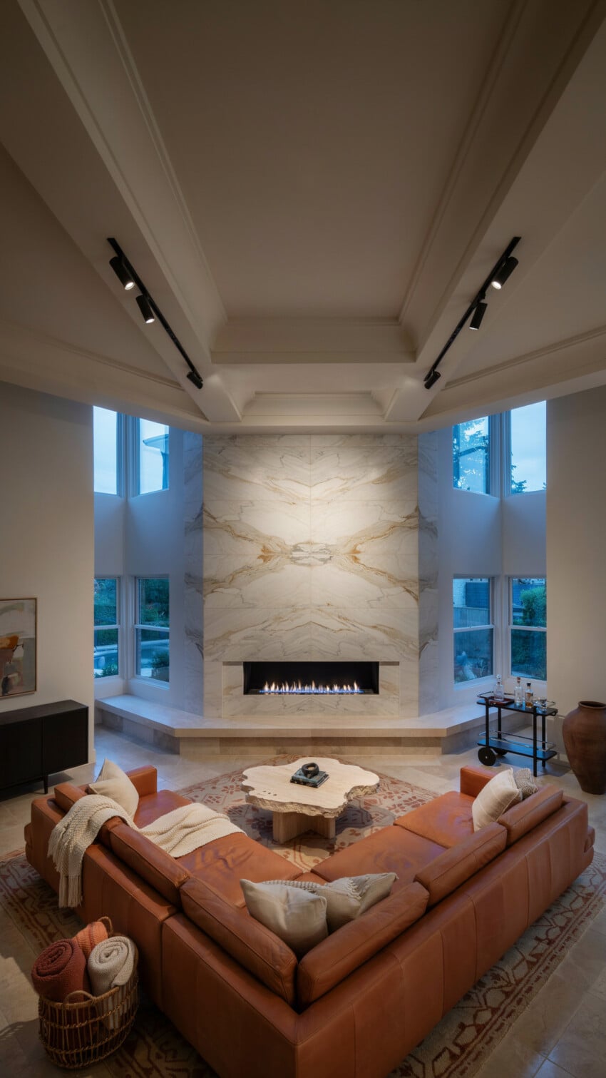 Corner Fireplace Design with Bookmatched Marble-Look Tile Wall